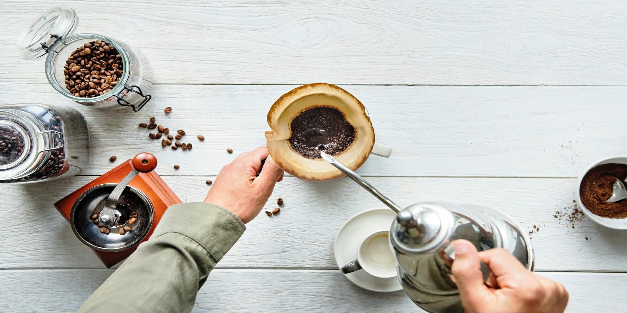 man pouring coffee into a drip maker