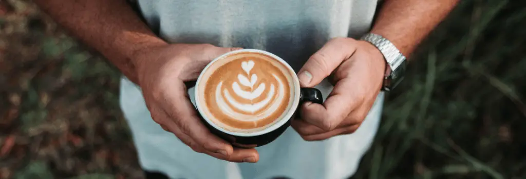 Man holding flat white coffee