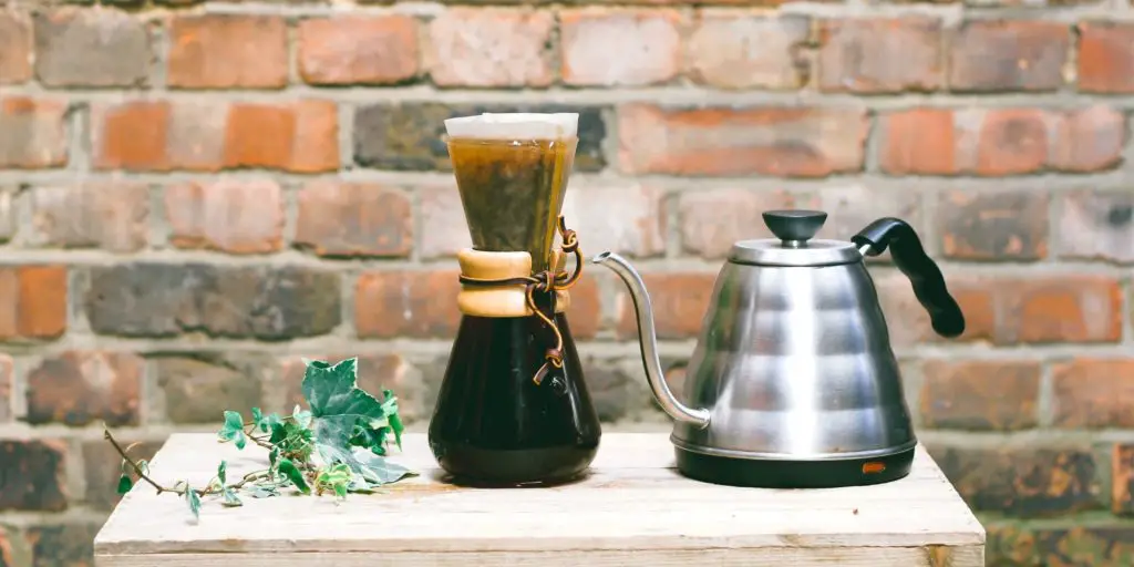 Chemex coffee maker next to gooseneck kettle