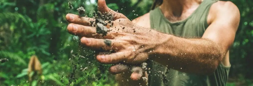 Farmer with dirt between hands