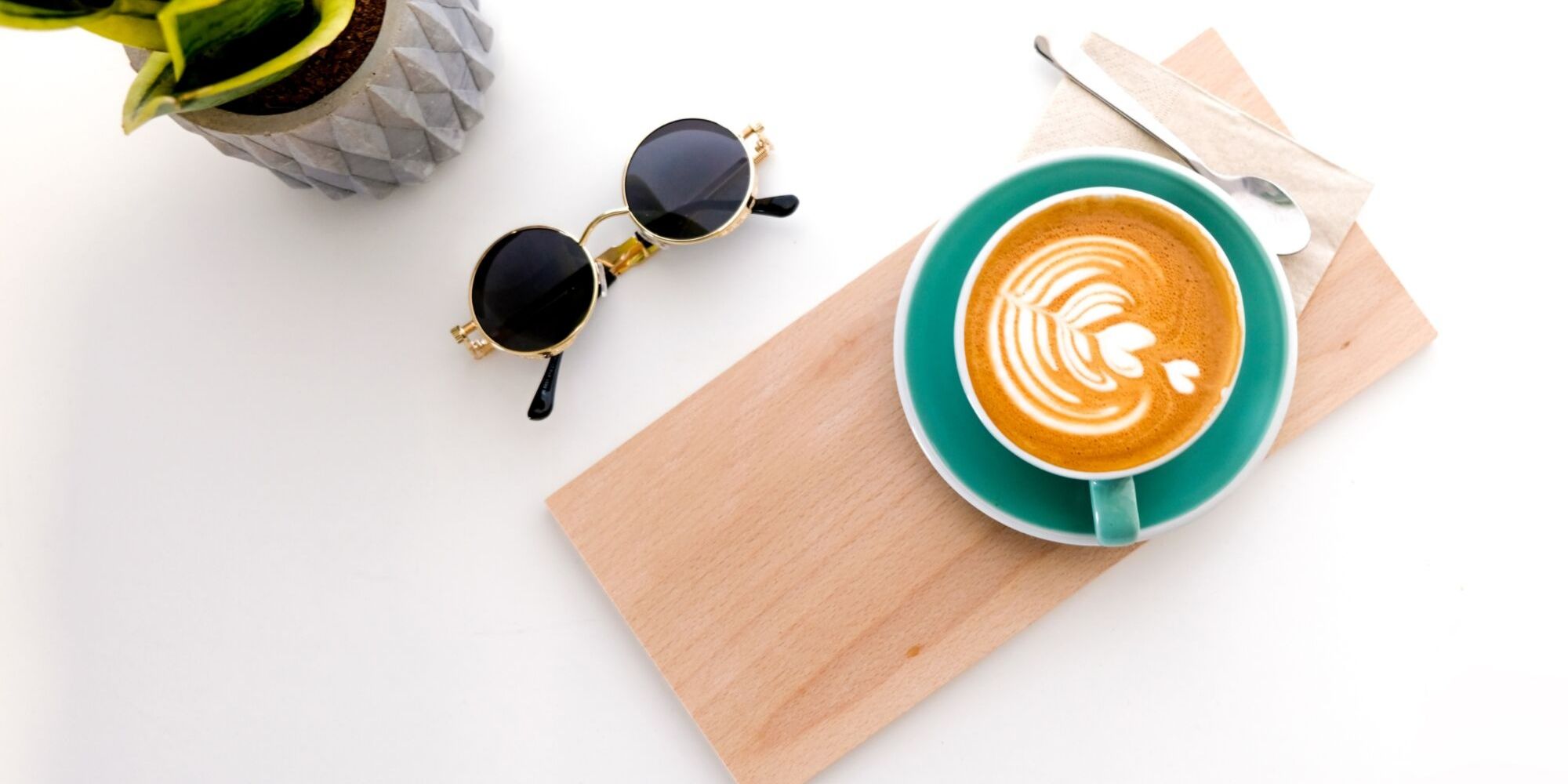 Specialty flat white coffee on table with plant