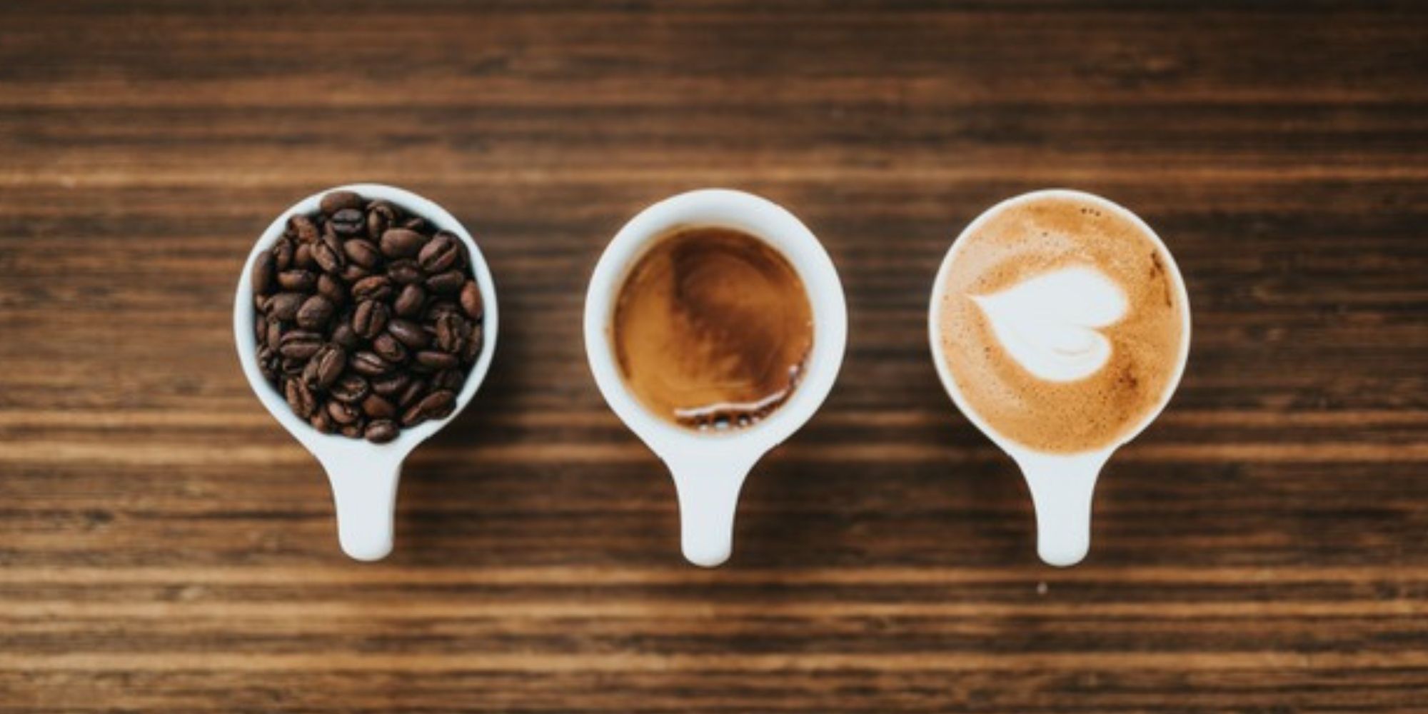 three white espresso cups filled with coffee