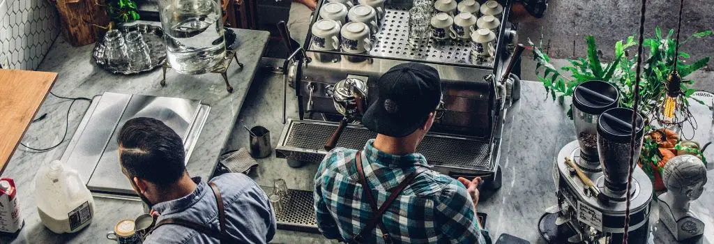 coffee shop and two baristas making coffee