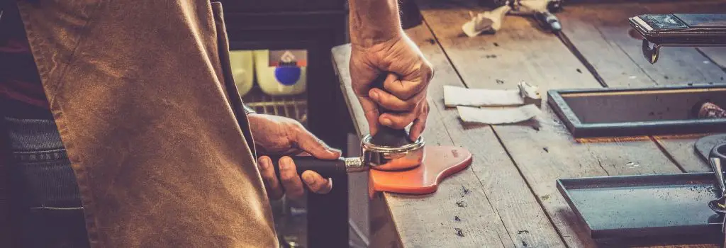 tamping coffee grounds, pull a perfect shot of espresso