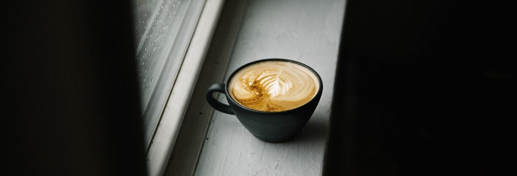latte coffee next to window