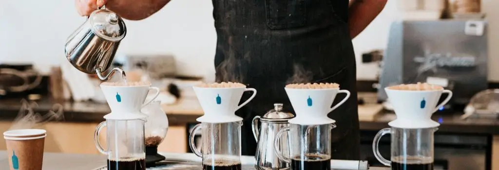 barista using gooseneck kettle with V60