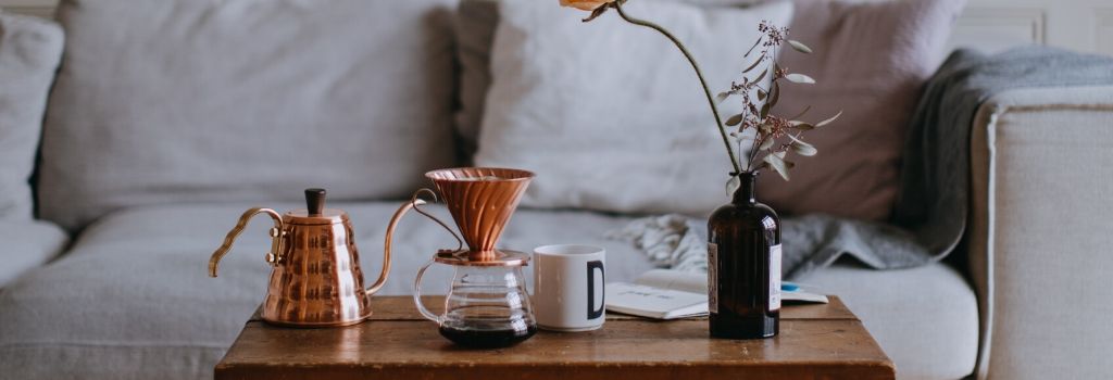 copper gooseneck kettle with v60 sitting on coffee table