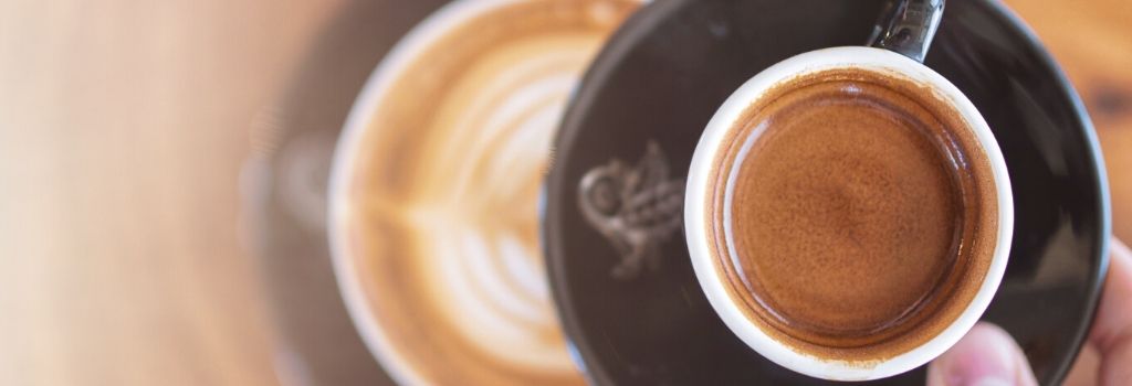 looking down into coffee with latte in back ground, pull a perfect shot of espresso