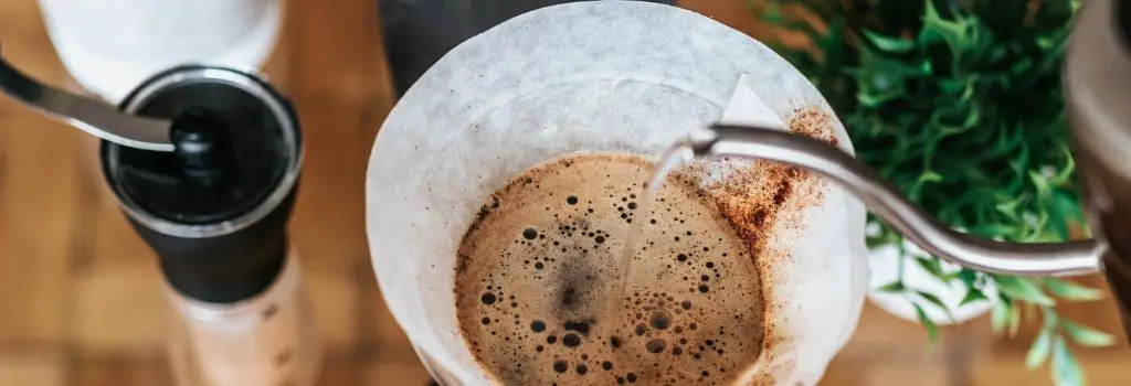 water pouring over coffee grounds