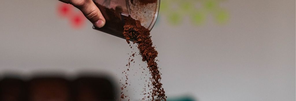 pouring ground coffee