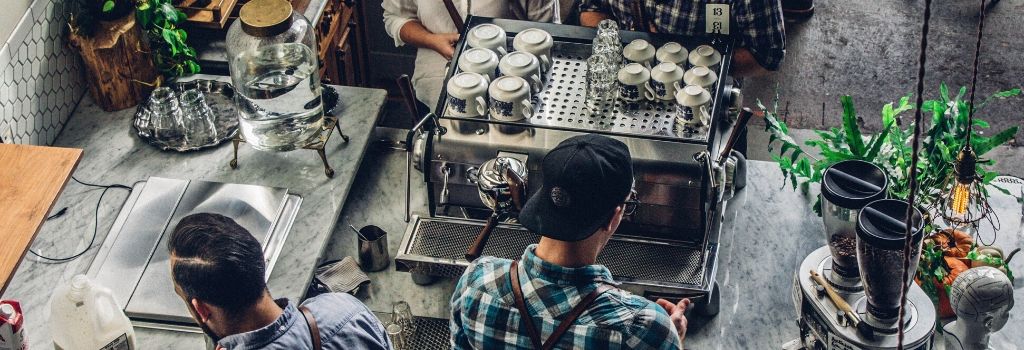 baristas making coffee with espresso machine