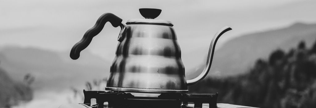 black and white image of gooseneck kettle on electric scales