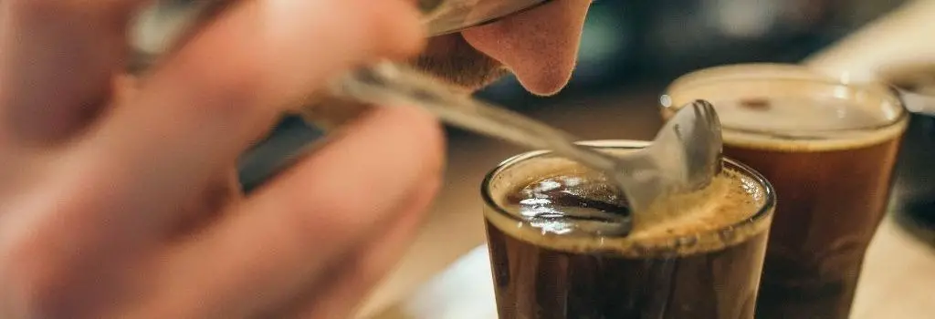 person smelling coffee, start drinking coffee