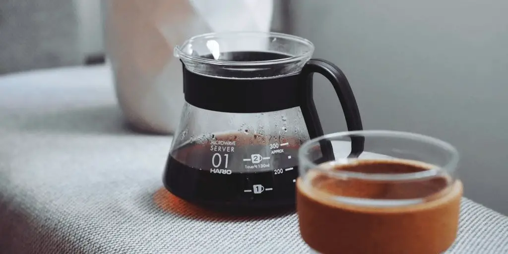 filtered black coffee next to a keep cup