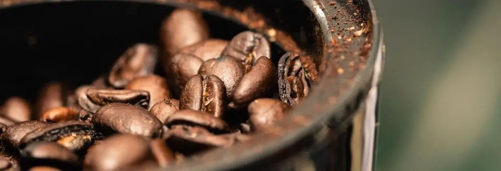 coffee beans being ground in grinder